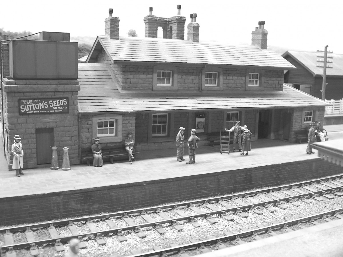 A clear study of the station's platform side, with figures and 'arched' chimney stacks. 