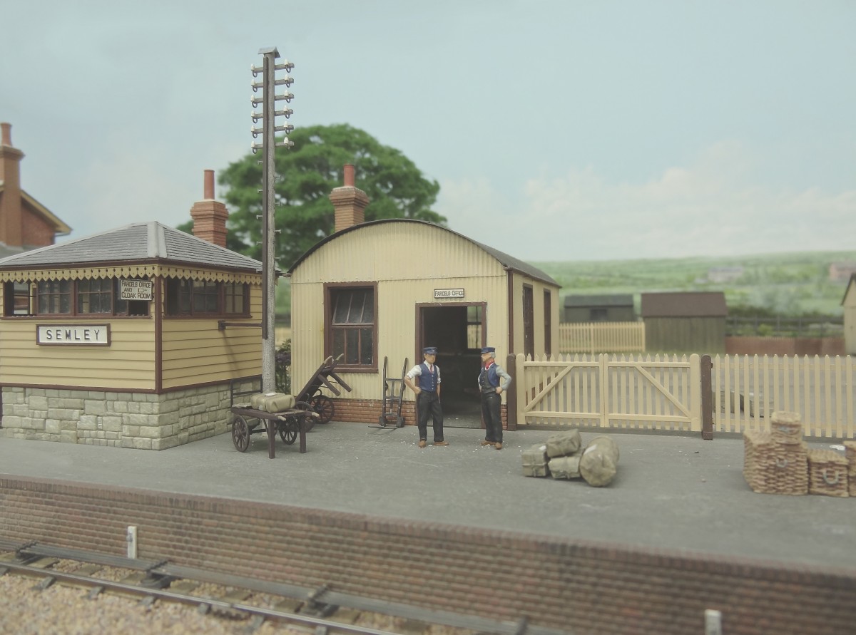 Some of the work at Missenden Abbey will be with 2D backscene rear panels, and this one appears behind Semley's small stone and timber L.S.W.R. signalbox and corrugated parcels office. The fabulous P4 layout now has it's most recent detail work in position. and the telegraph pole, station staff, barrows and parcels complete the scene to the very highest standard of presentation. Photo courtesy of Martin Finney 
